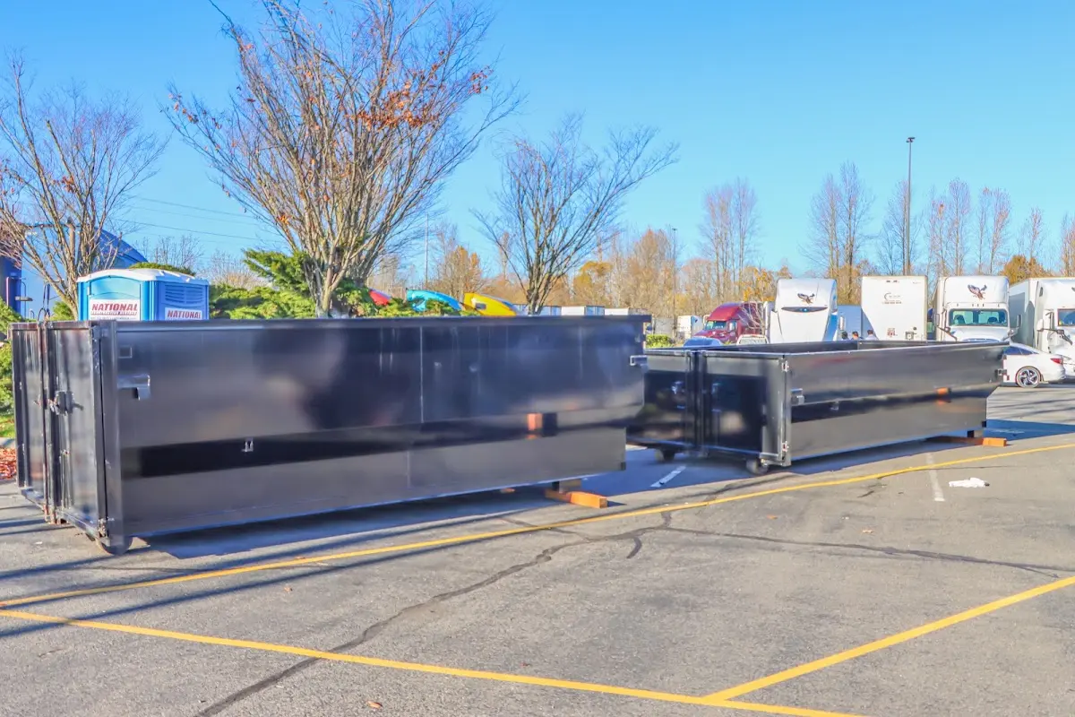 Professional dumpster rental service with roll-off container on residential driveway in Medulla
